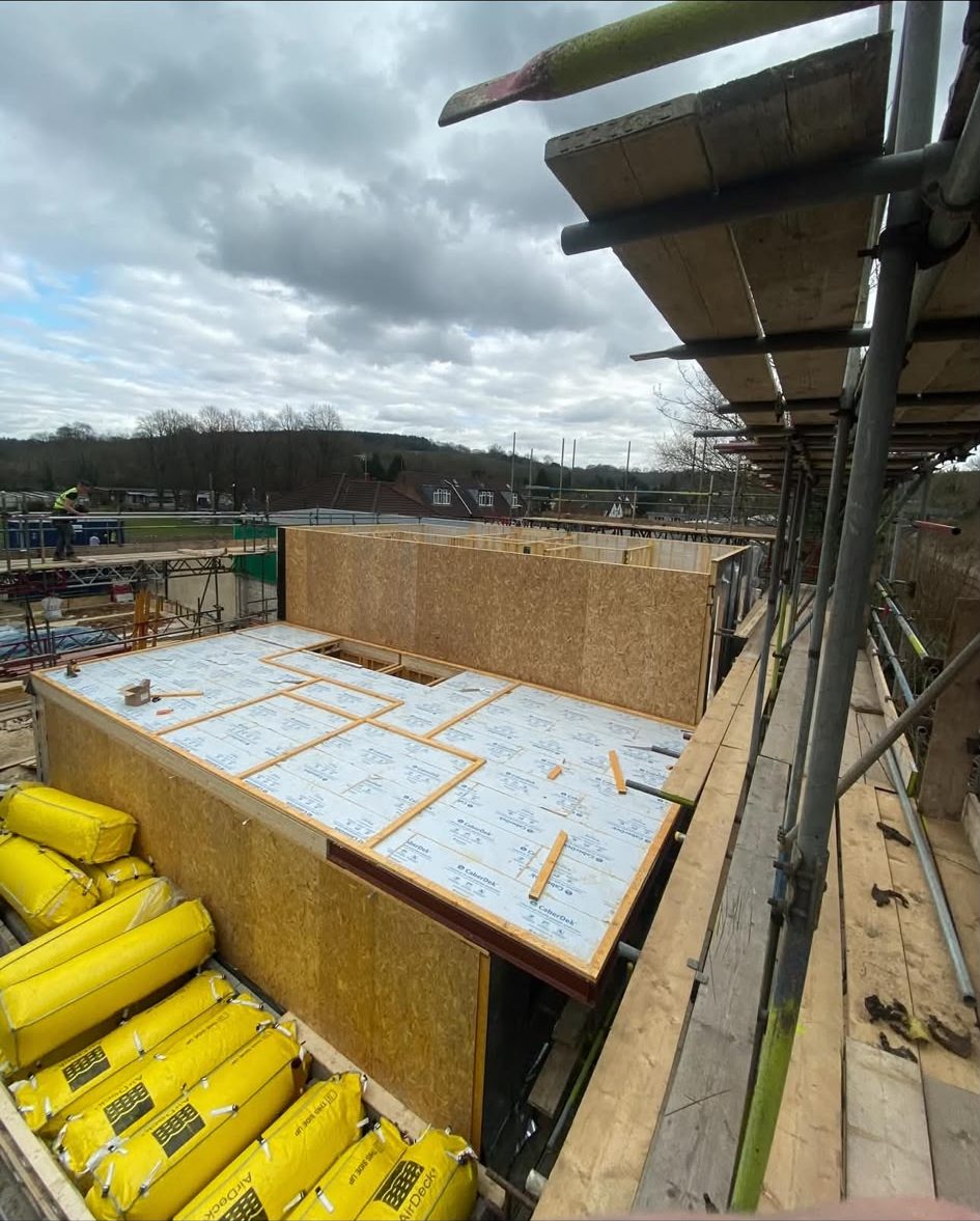 Timber frame walls erected with the deck sheeted and insulated