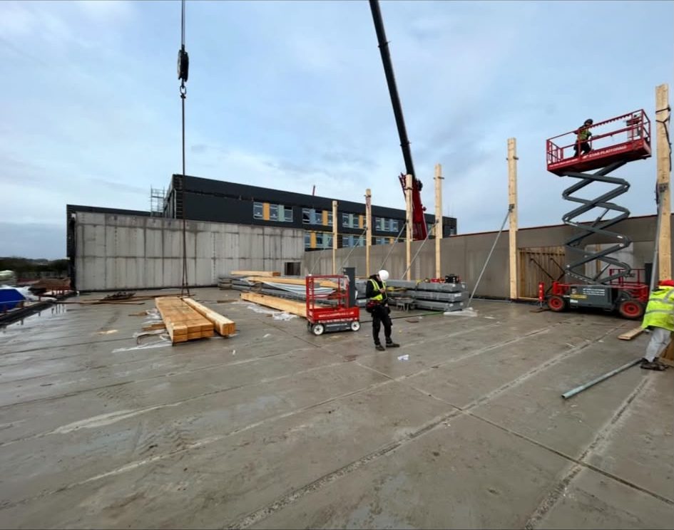Structural steel and timber package being craned into place
