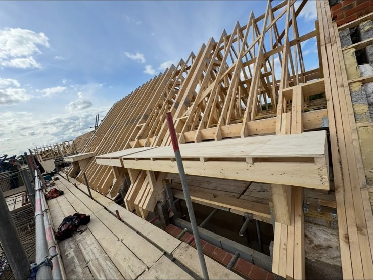 Hand-cut roof structure over brickwork