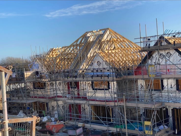 New build timber frame homes with truss roofs erected
